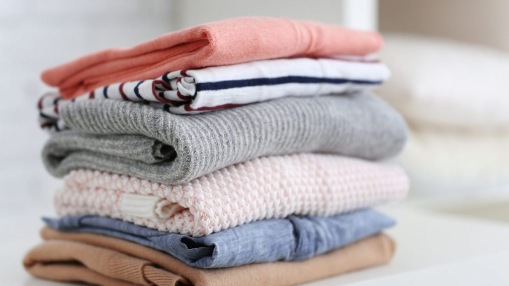 stack of clothes to sell on vinted with tips